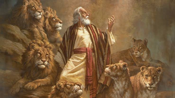 A picture of Daniel praying in the lions’ den